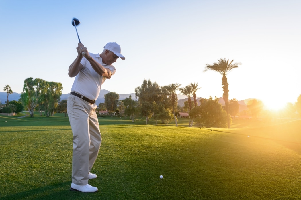 A man lines up a shot on the fairway